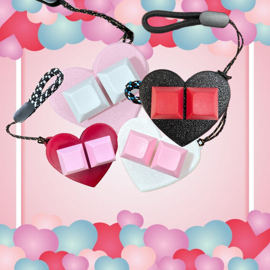 It's a 3D heart-shaped finger fidget. With keyboard keys to keep your fingers busy and it is on a keychain and it comes in pink, black, white and red.
