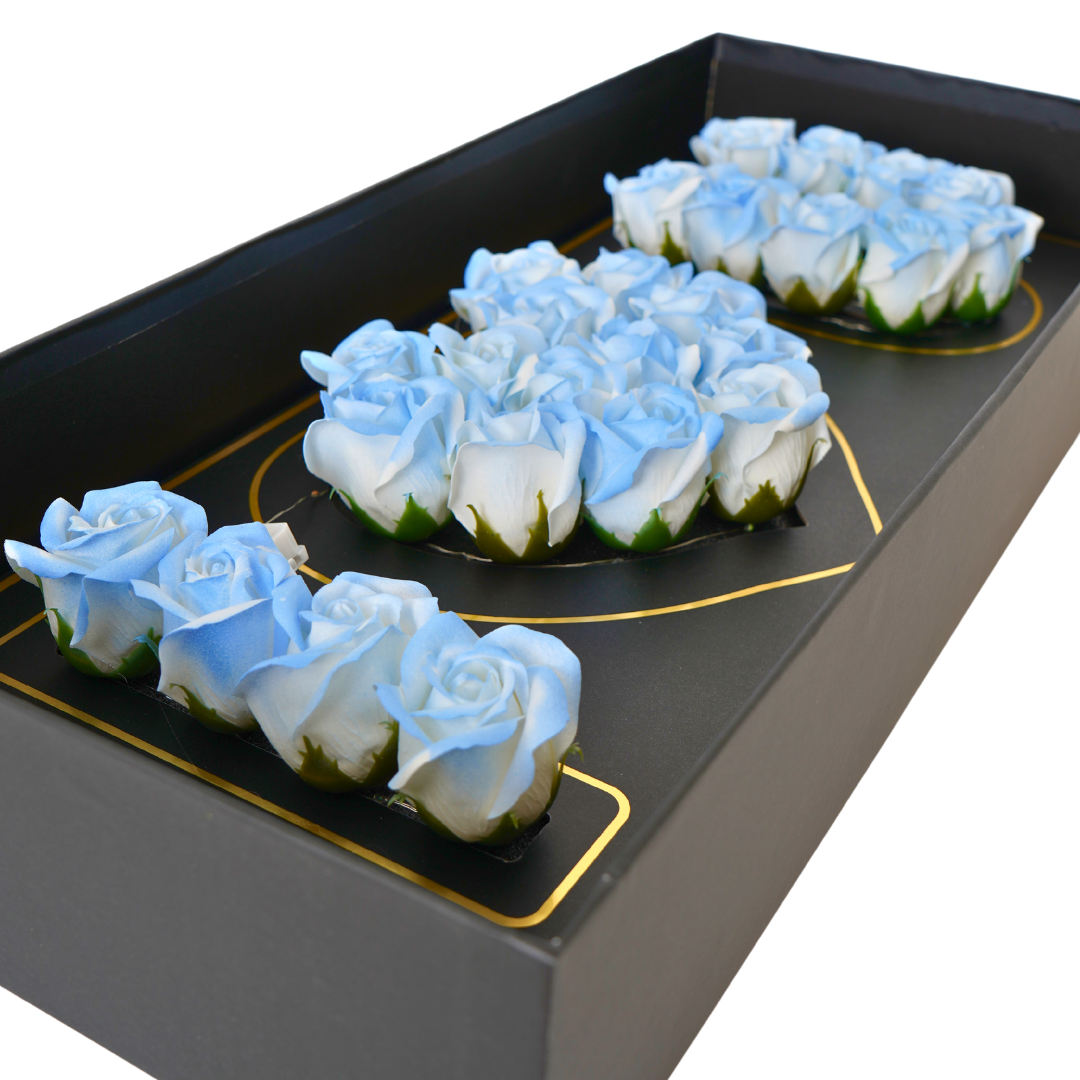 Black floral box with blue Eternal flowers that say I love you and has strings of small LED lights.