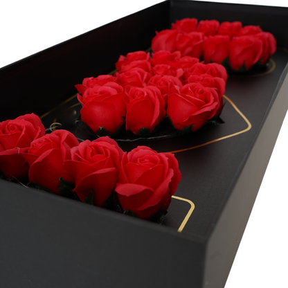 Black floral box with red Eternal flowers that say I love you and has strings of small LED lights.